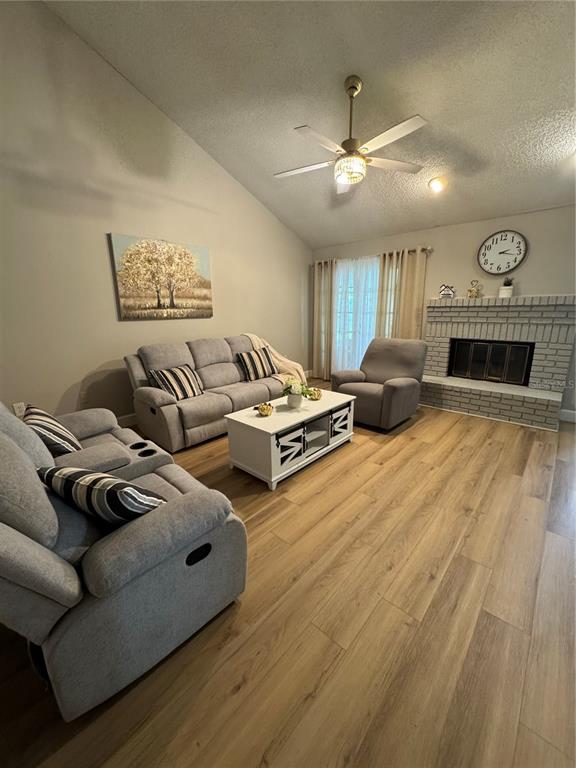 2633 Lanier Road Kissimmee, FL 34744 - Photo 10 of 45 a living room with furniture and a fireplace