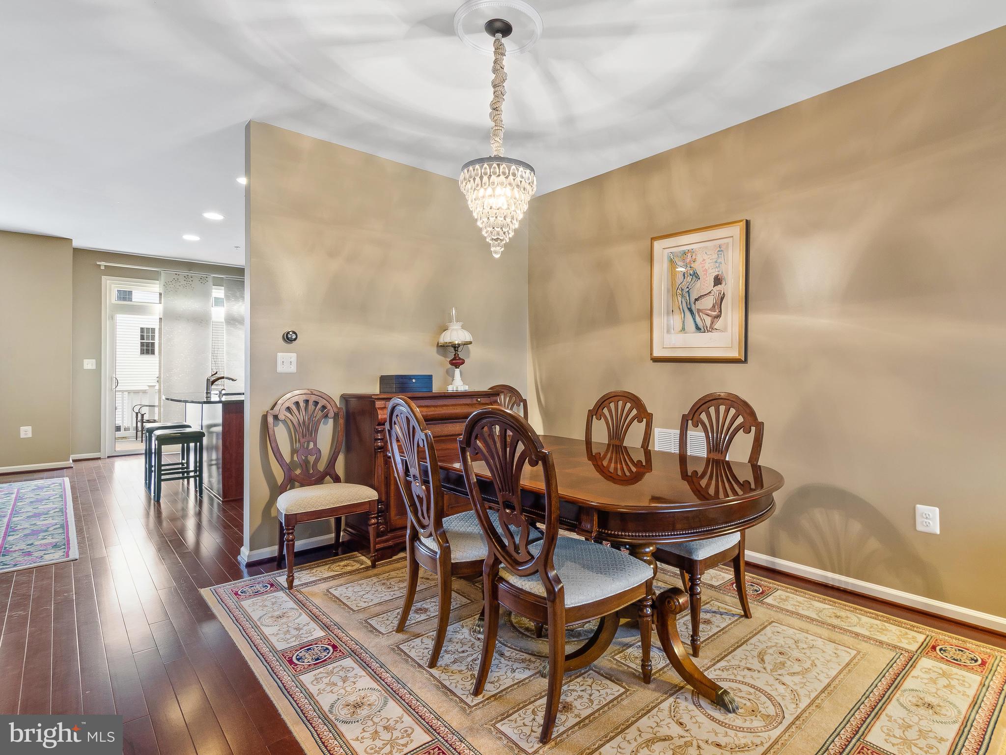 13610 Stargazer Lane Silver Spring, MD 20906 - Photo 14 of 43 a view of a dining room with furniture wooden floor and chandelier