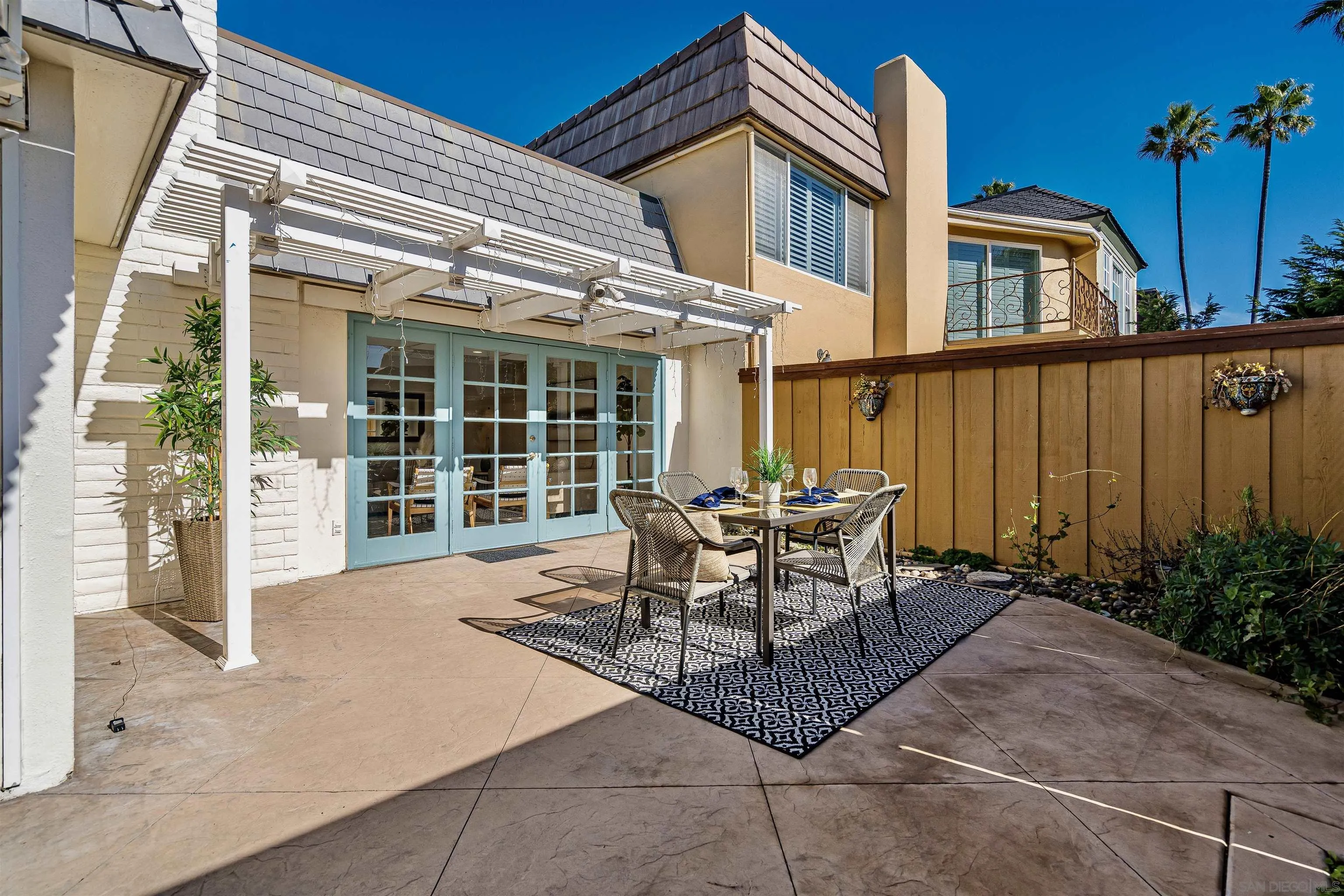 20 GingerTree Lane Coronado, CA 92118 - Photo 29 of 45 a view of a patio with table and chairs and potted plants