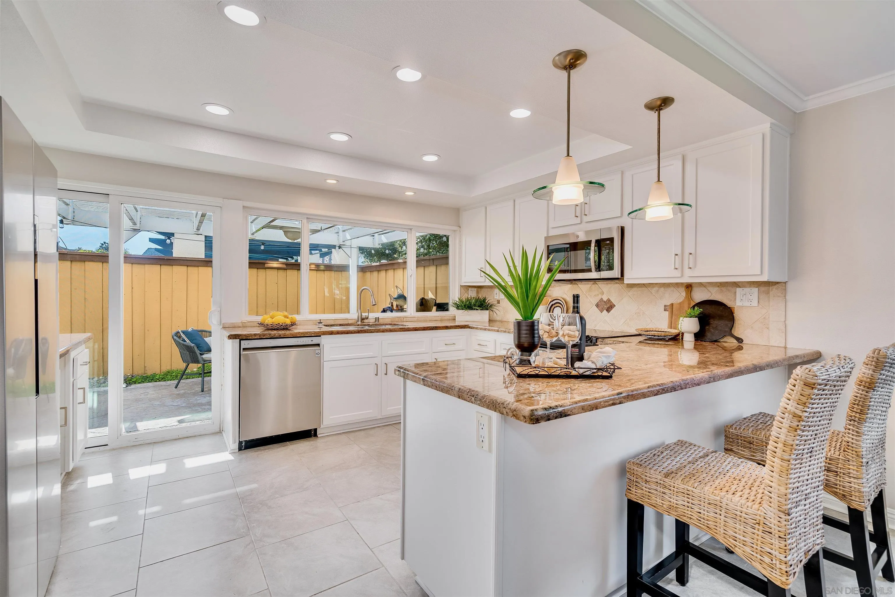20 GingerTree Lane Coronado, CA 92118 - Photo 6 of 45 a kitchen with a sink refrigerator and cabinets