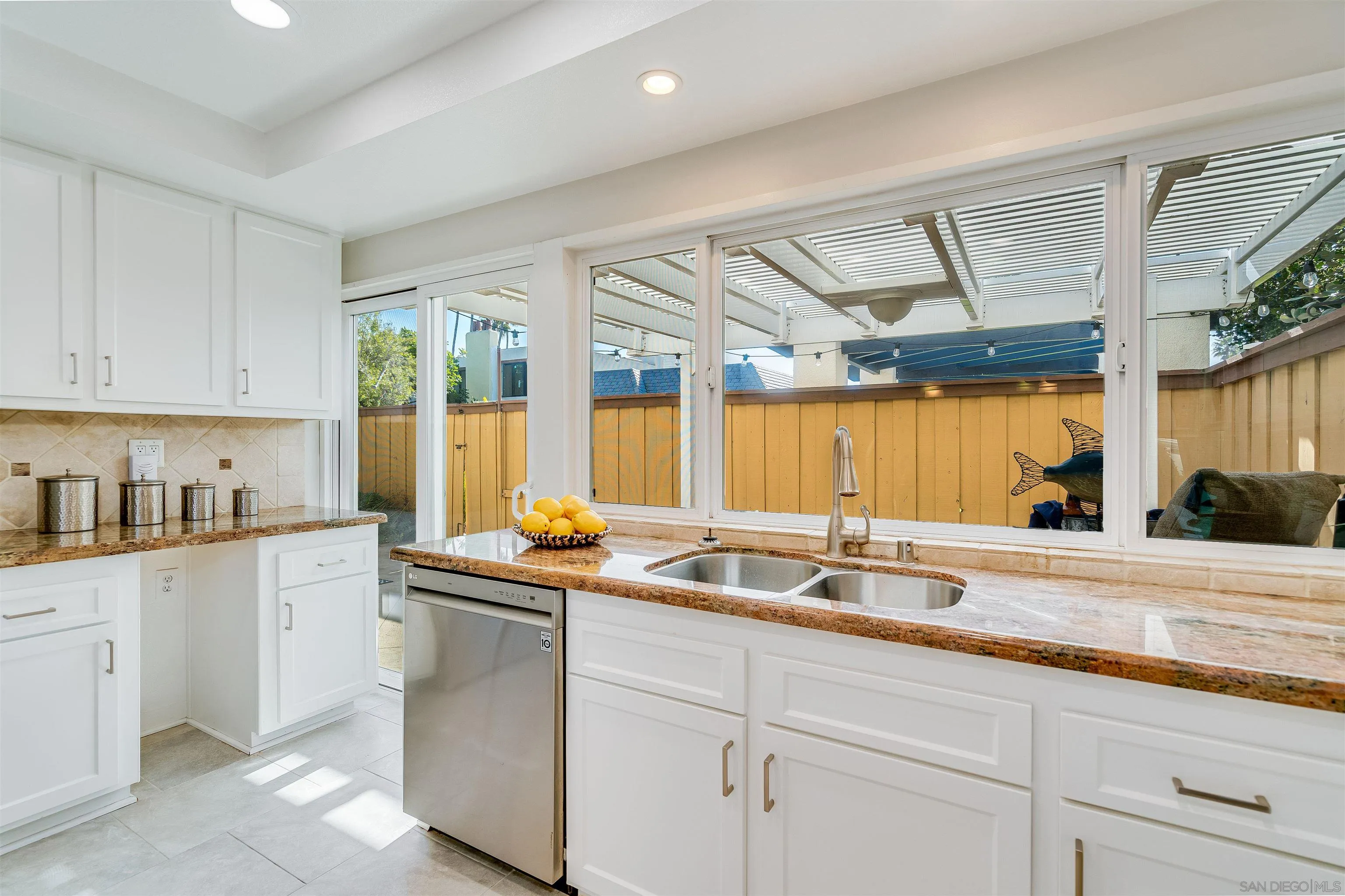 20 GingerTree Lane Coronado, CA 92118 - Photo 8 of 45 a kitchen with stainless steel appliances granite countertop a sink and a white cabinets