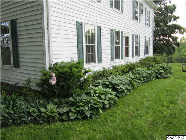 268 Rivanna Mills Road Palmyra, VA 22963 - Photo 18 of 31 a view of a house with a garden