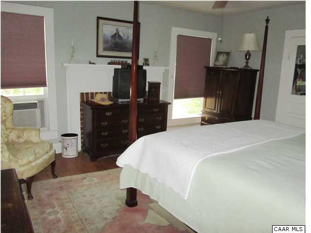 268 Rivanna Mills Road Palmyra, VA 22963 - Photo 27 of 31 a bedroom with a bed and dresser