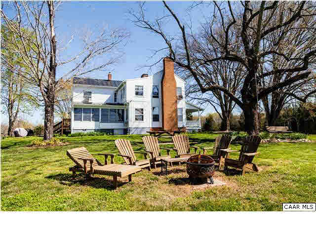 268 Rivanna Mills Road Palmyra, VA 22963 - Photo 8 of 31 a backyard of a house with table and chairs