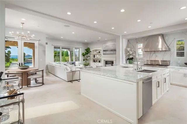 a kitchen with stainless steel appliances kitchen island granite countertop a stove and a sink