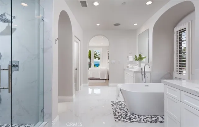 a bathroom with a bathtub a sink and a window
