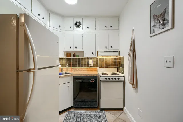 a kitchen with stainless steel appliances a stove a refrigerator and cabinets