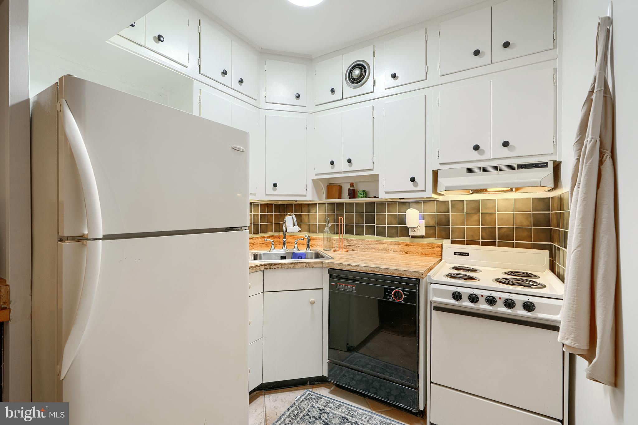 3601 Greenway, Unit 303 Baltimore, MD 21218 - Photo 14 of 30 a kitchen with stainless steel appliances a refrigerator a stove and white cabinets