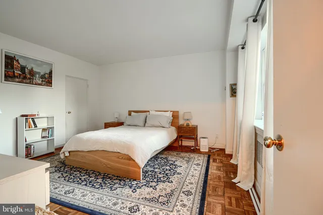 a bedroom with a bed and a book shelf