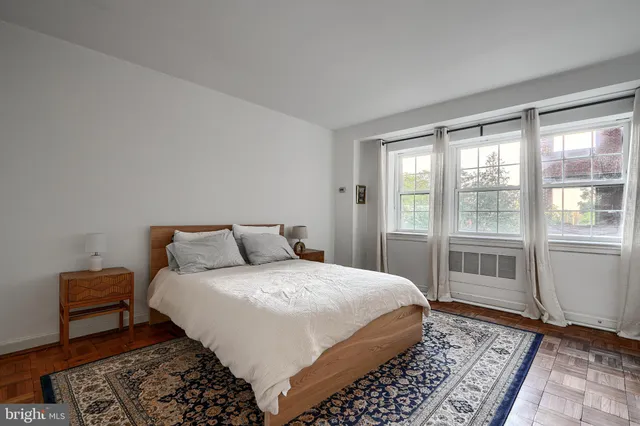 a bedroom with a large bed and a rug