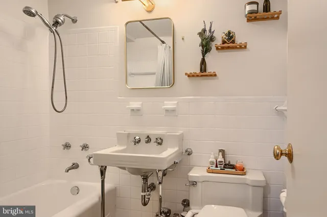 a bathroom with a sink mirror and toilet