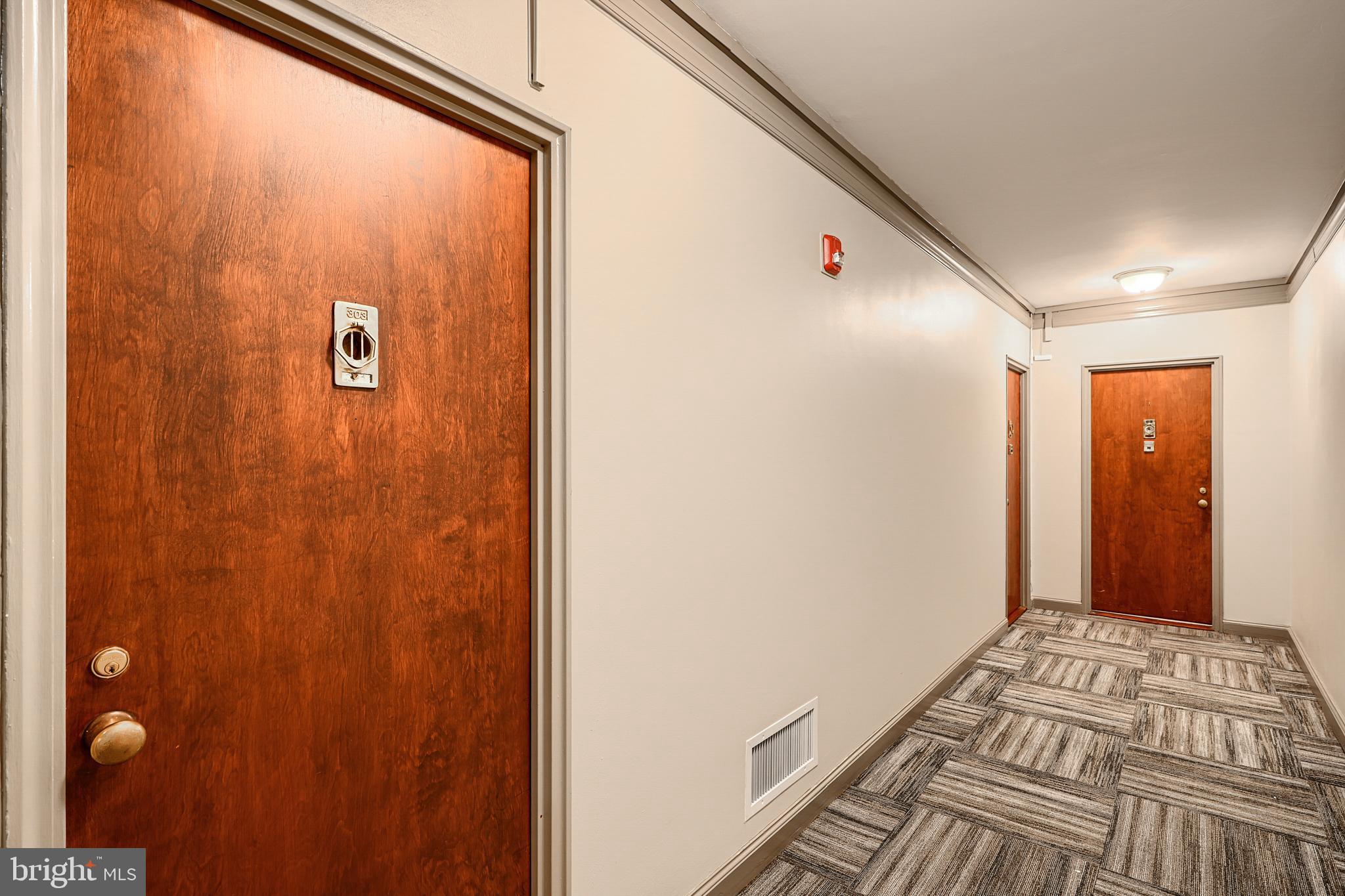 3601 Greenway, Unit 303 Baltimore, MD 21218 - Photo 22 of 30 a view of a hallway with a bedroom