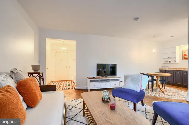 a living room with furniture and a flat screen tv