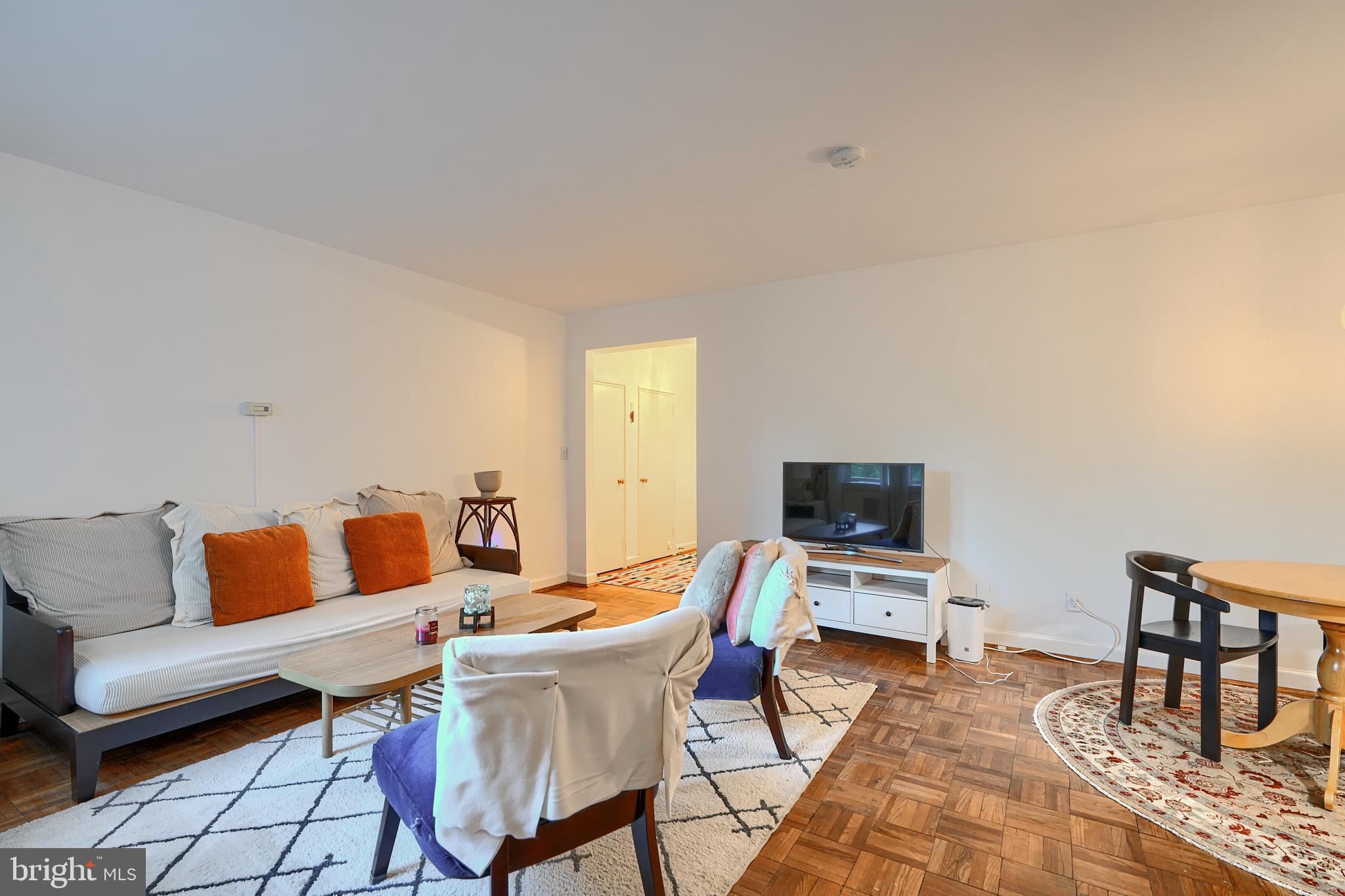 3601 Greenway, Unit 303 Baltimore, MD 21218 - Photo 5 of 30 a living room with furniture a flat screen tv and a table