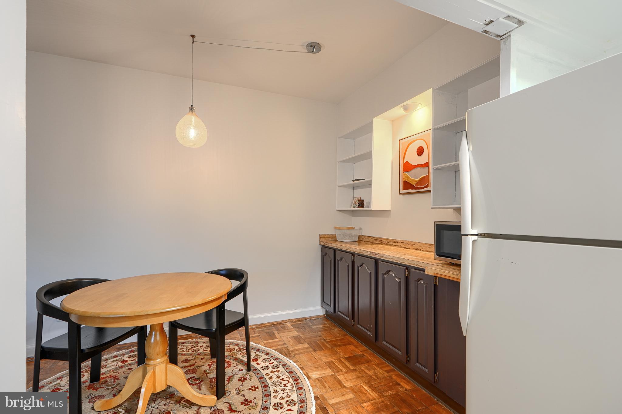 3601 Greenway, Unit 303 Baltimore, MD 21218 - Photo 9 of 30 a kitchen with stainless steel appliances a refrigerator and a table