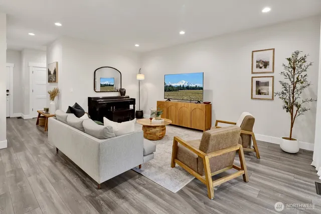 a living room with furniture and a potted plant