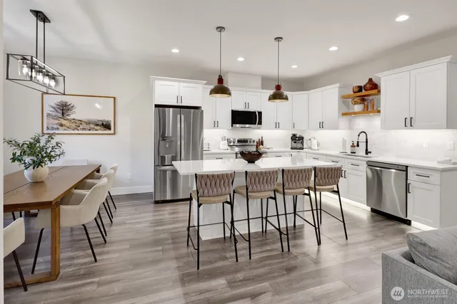 a view of kitchen with cabinets table and chairs