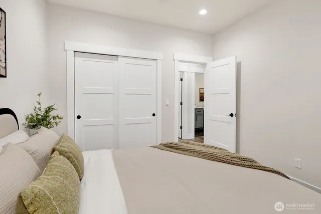 a bedroom with a bed and a potted plant