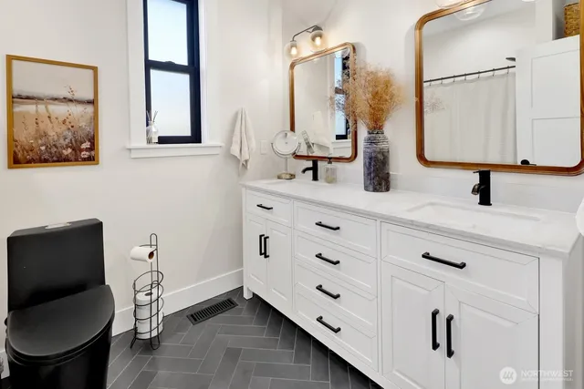 a bathroom with a double vanity sink and a mirror