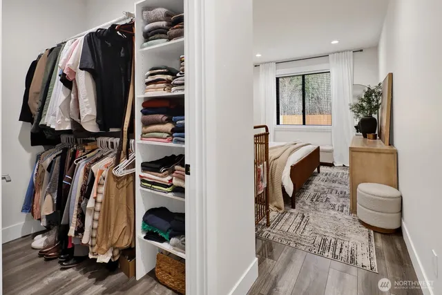 a view of walk in closet with clothes and shoes