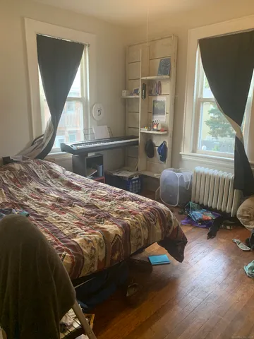 a bedroom with a bed and a book shelf