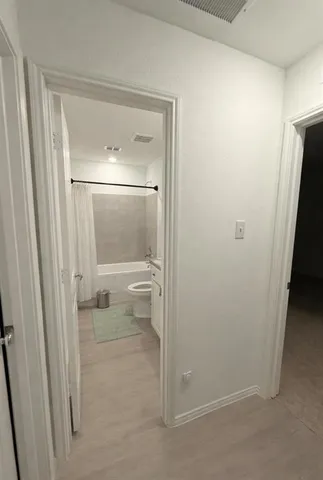 a bathroom with a glass shower door and a sink