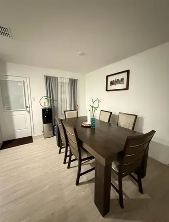 a view of a dining room with furniture and window