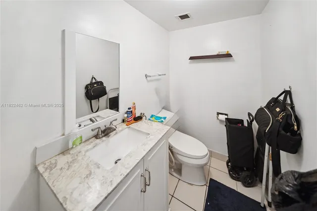 a bathroom with a sink toilet and vanity