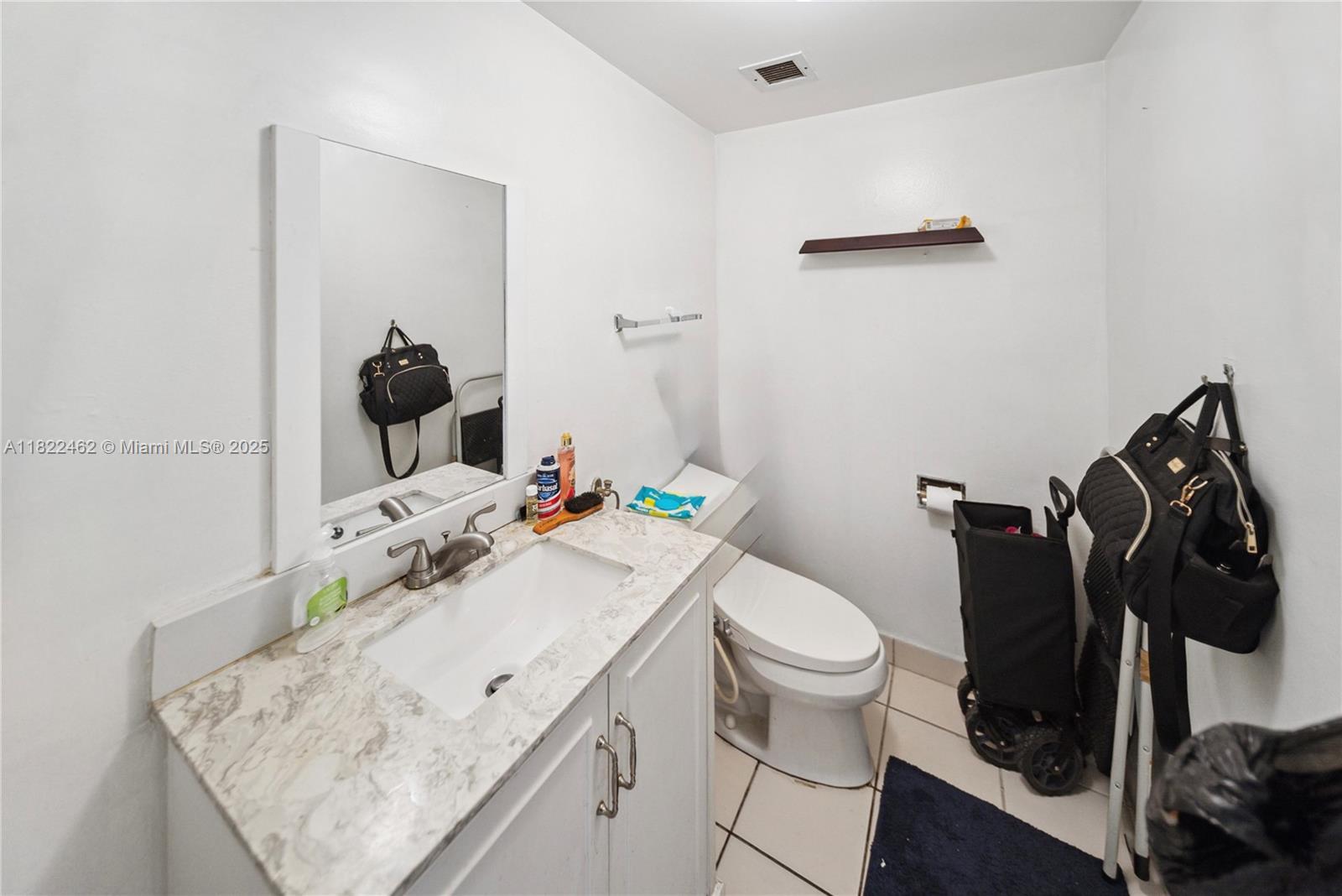 13499 Biscayne Boulevard, Unit 703 North Miami, FL 33181 - Photo 14 of 38 a bathroom with a sink toilet and vanity