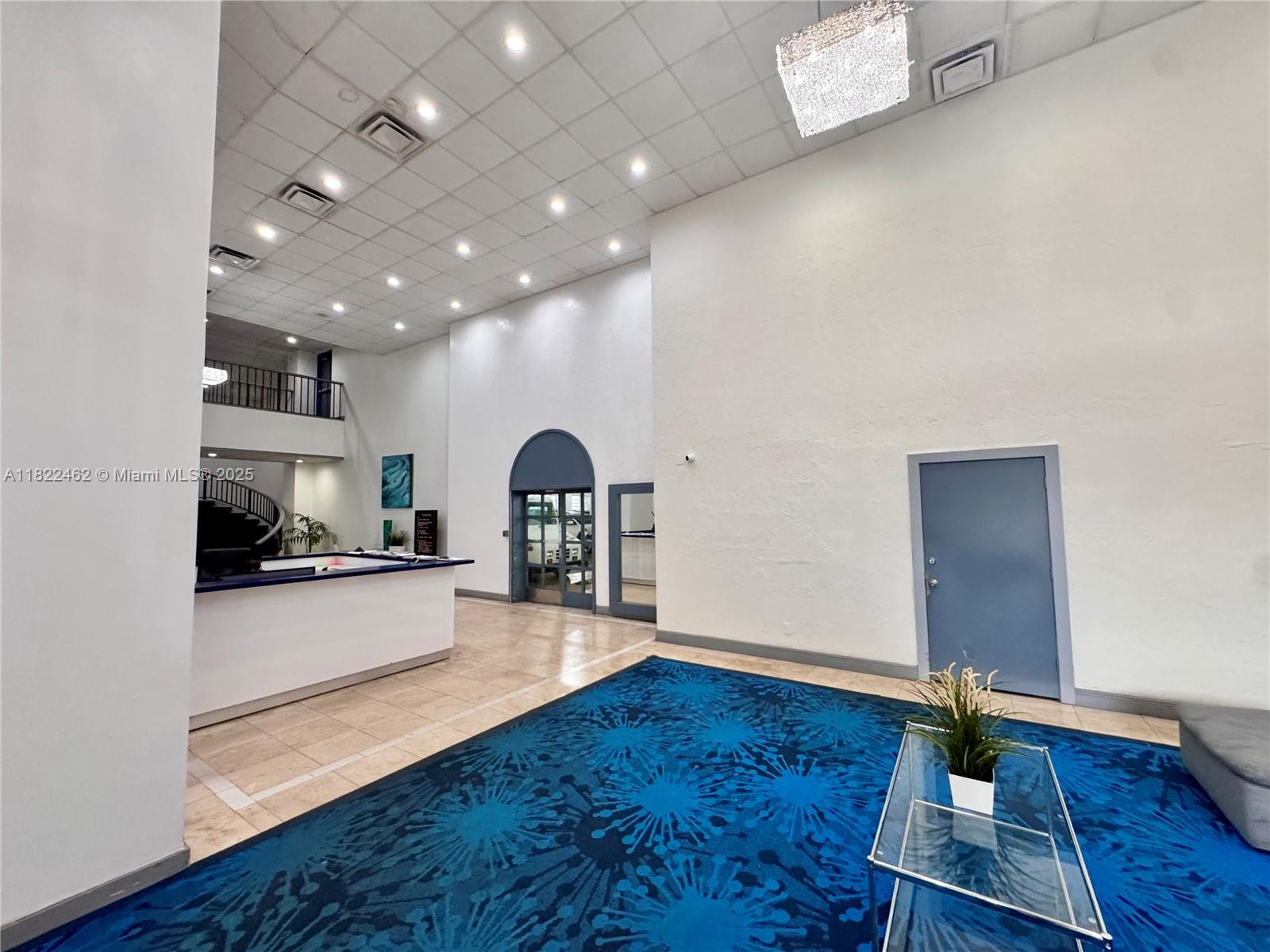 13499 Biscayne Boulevard, Unit 703 North Miami, FL 33181 - Photo 18 of 38 a living room with hard wood floors a fireplace and a view of kitchen