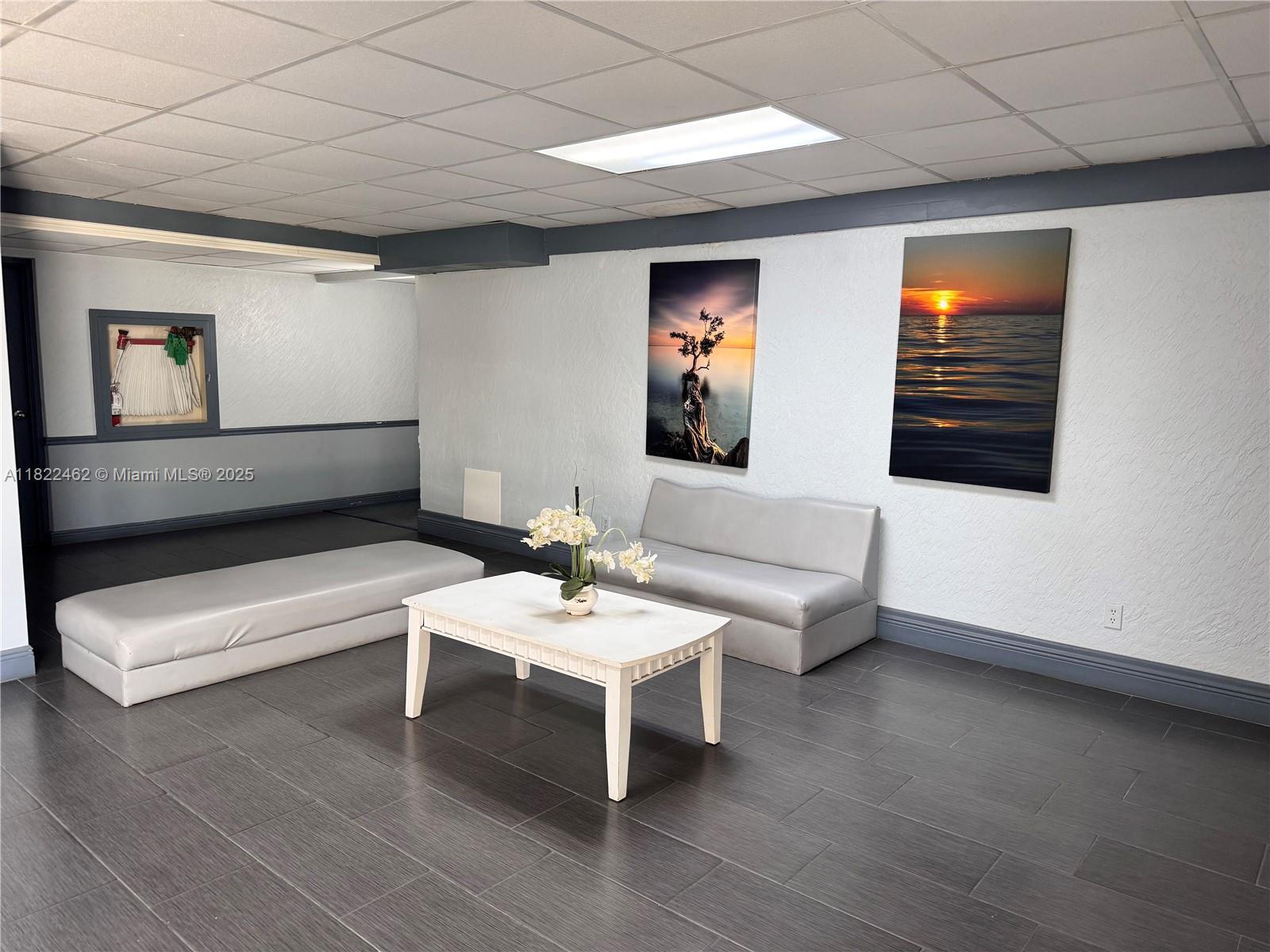 13499 Biscayne Boulevard, Unit 703 North Miami, FL 33181 - Photo 21 of 38 a living room with furniture and a flat screen tv