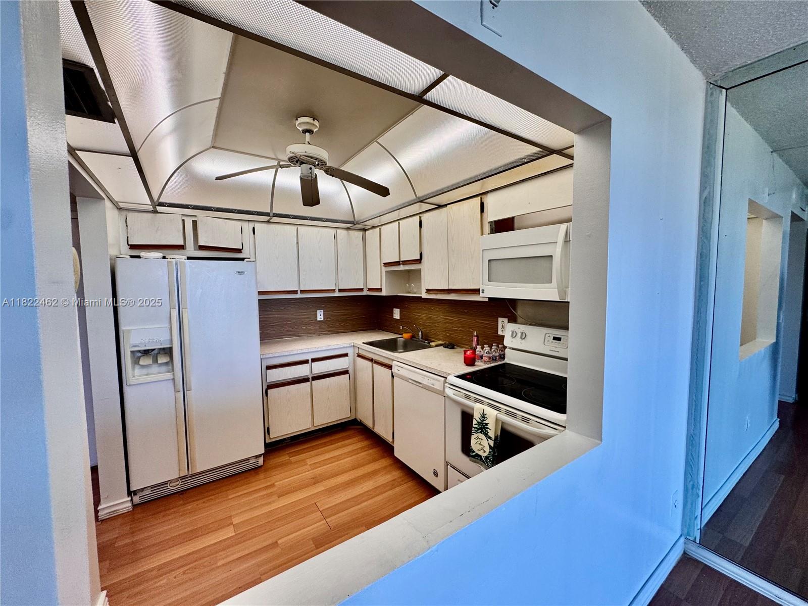 13499 Biscayne Boulevard, Unit 703 North Miami, FL 33181 - Photo 25 of 38 a kitchen with stainless steel appliances granite countertop a refrigerator and a stove