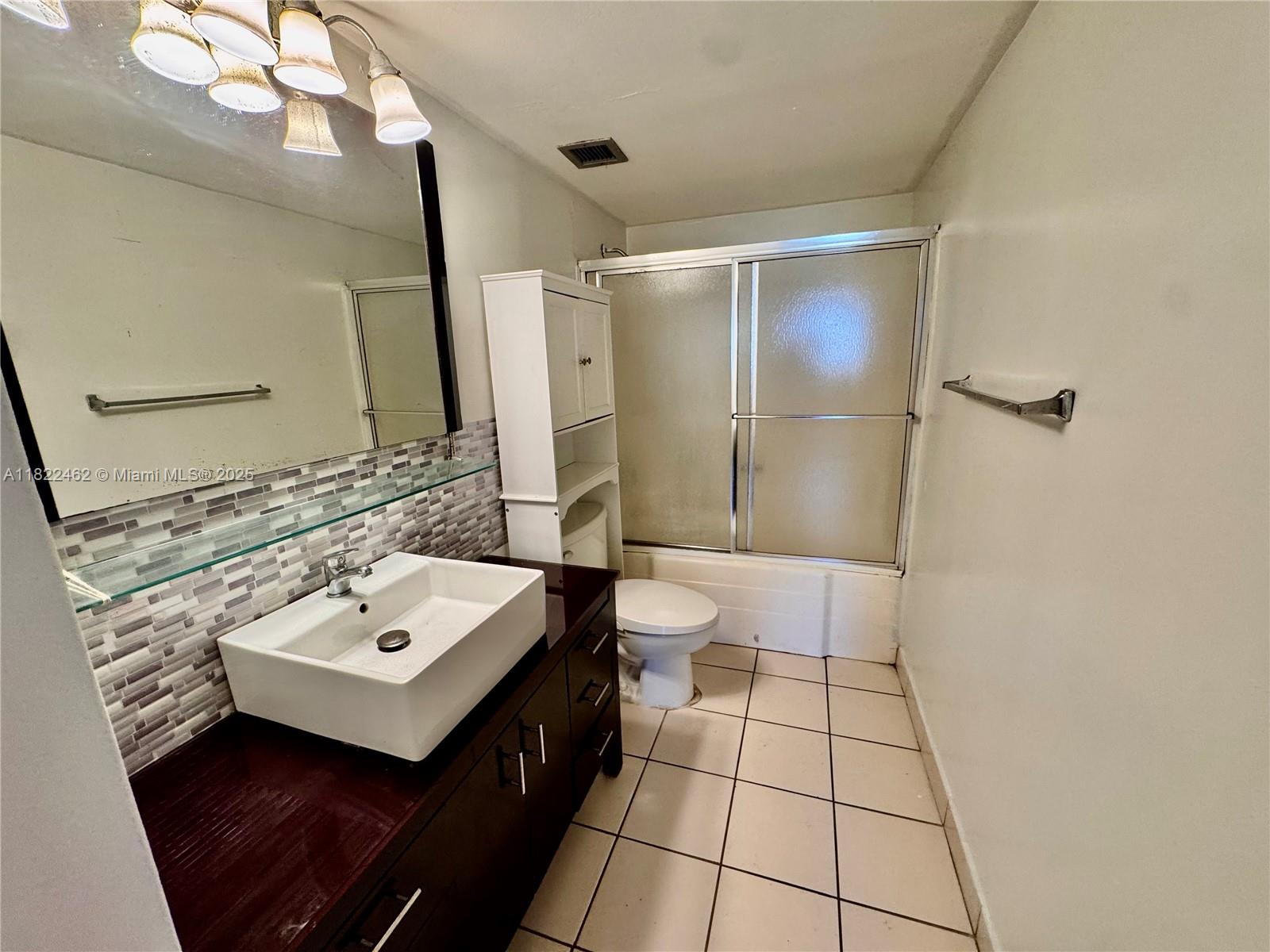 13499 Biscayne Boulevard, Unit 703 North Miami, FL 33181 - Photo 26 of 38 a bathroom with a sink a toilet and shower