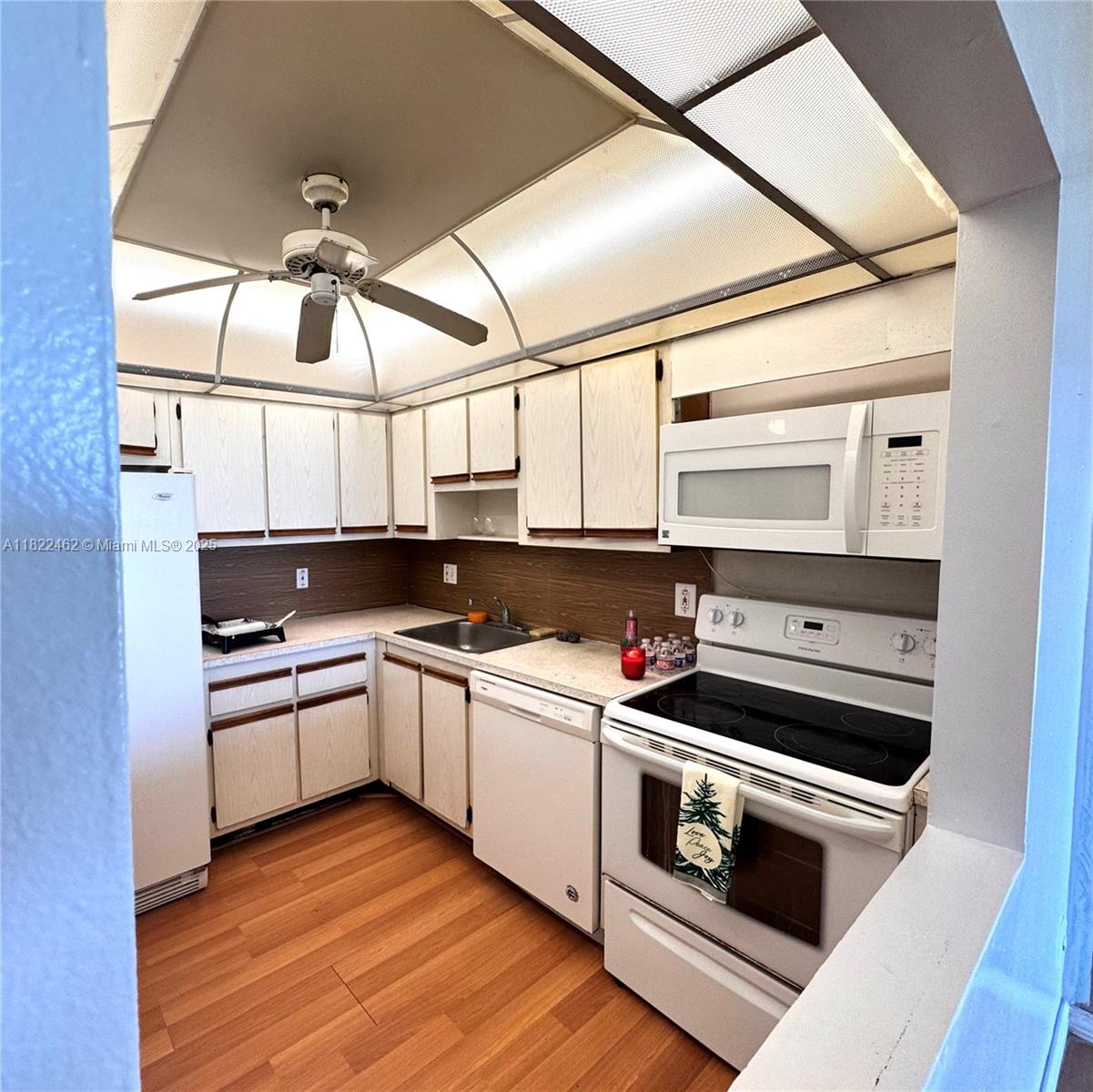 13499 Biscayne Boulevard, Unit 703 North Miami, FL 33181 - Photo 35 of 38 a kitchen with a stove and a microwave