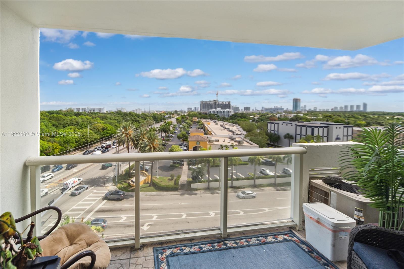 13499 Biscayne Boulevard, Unit 703 North Miami, FL 33181 - Photo 4 of 38 a view of a balcony with wooden floor and city view
