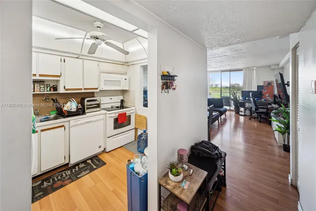 a kitchen with sink cabinets and wooden floor