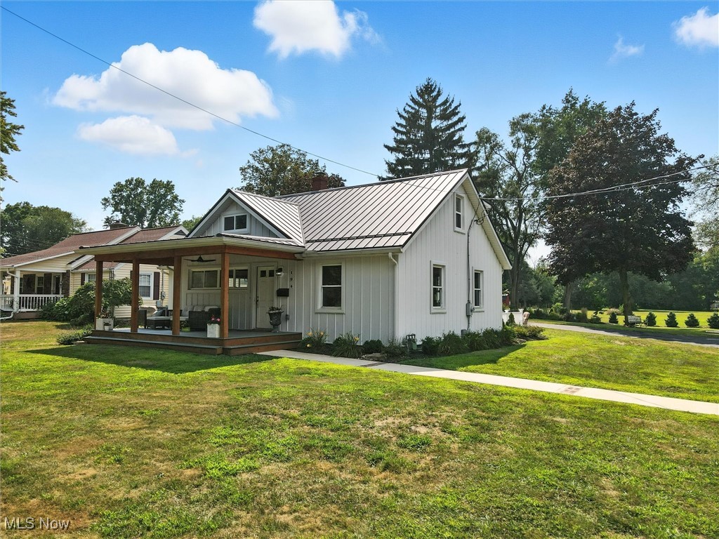 194 Ansel Road Geneva, OH 44041 - Photo 1 of 41 Modern farmhouse style home with a standing seam roof, a metal roof, a front lawn, board and batten siding, and covered porch
