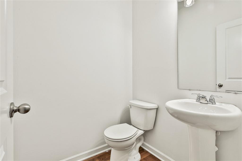 7365 St Peter Way Fairburn, GA 30213 - Photo 11 of 19 a bathroom with a toilet sink and mirror