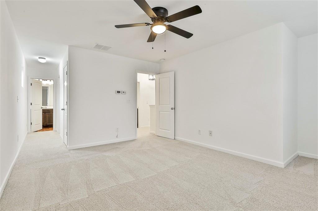7365 St Peter Way Fairburn, GA 30213 - Photo 13 of 19 an empty room with fan and a ceiling fan