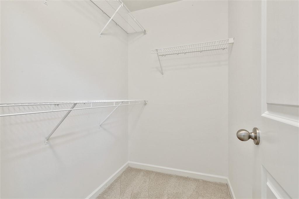 7365 St Peter Way Fairburn, GA 30213 - Photo 14 of 19 a view of a room with racks on the wall