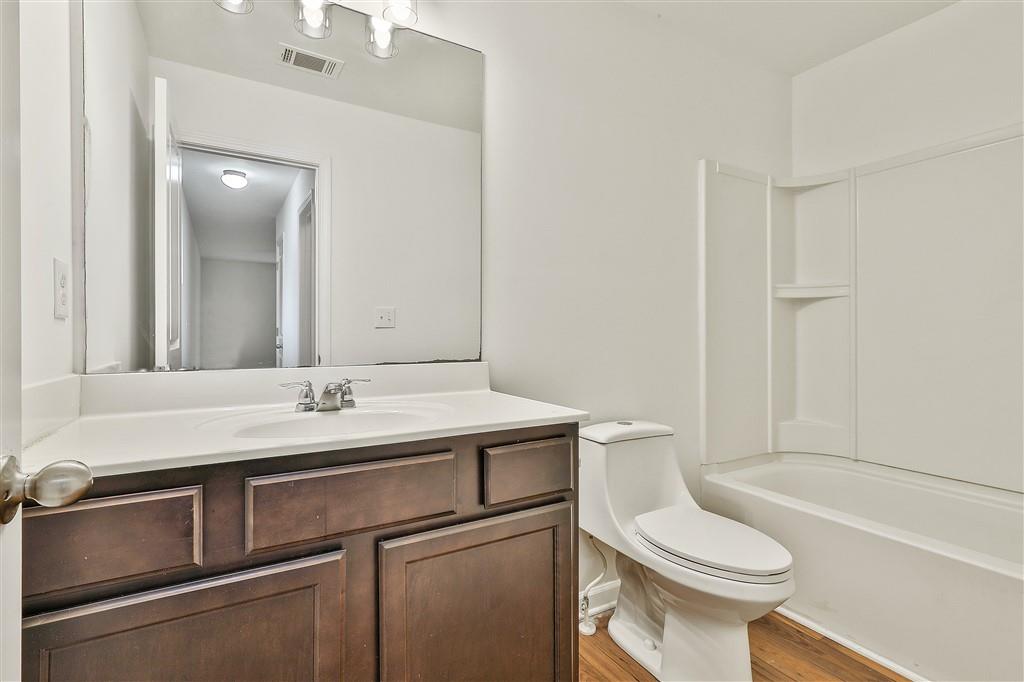 7365 St Peter Way Fairburn, GA 30213 - Photo 15 of 19 a bathroom with a sink a toilet and shower