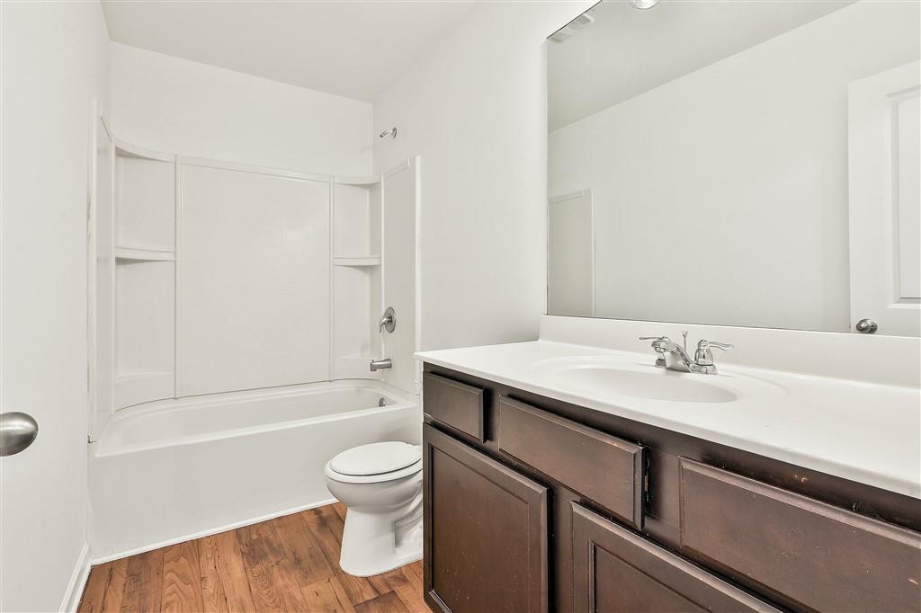 7365 St Peter Way Fairburn, GA 30213 - Photo 18 of 19 a bathroom with a sink a toilet and a bathtub