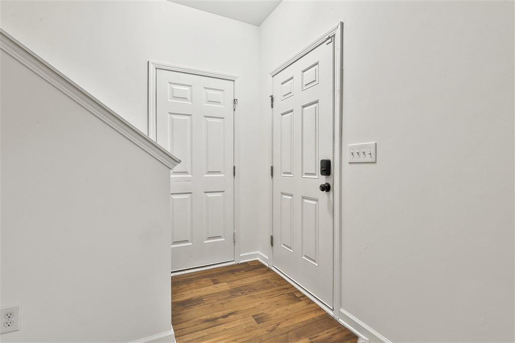 7365 St Peter Way Fairburn, GA 30213 - Photo 3 of 19 a view of a hallway with wooden floor and entryway