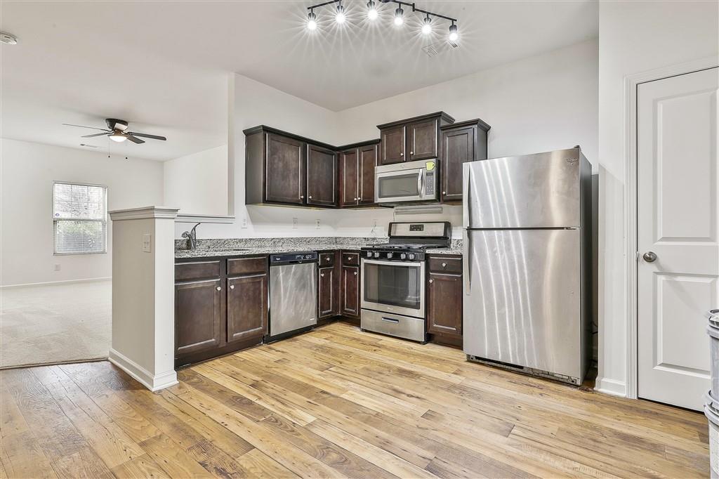 7365 St Peter Way Fairburn, GA 30213 - Photo 6 of 19 a kitchen with stainless steel appliances granite countertop a refrigerator stove and sink
