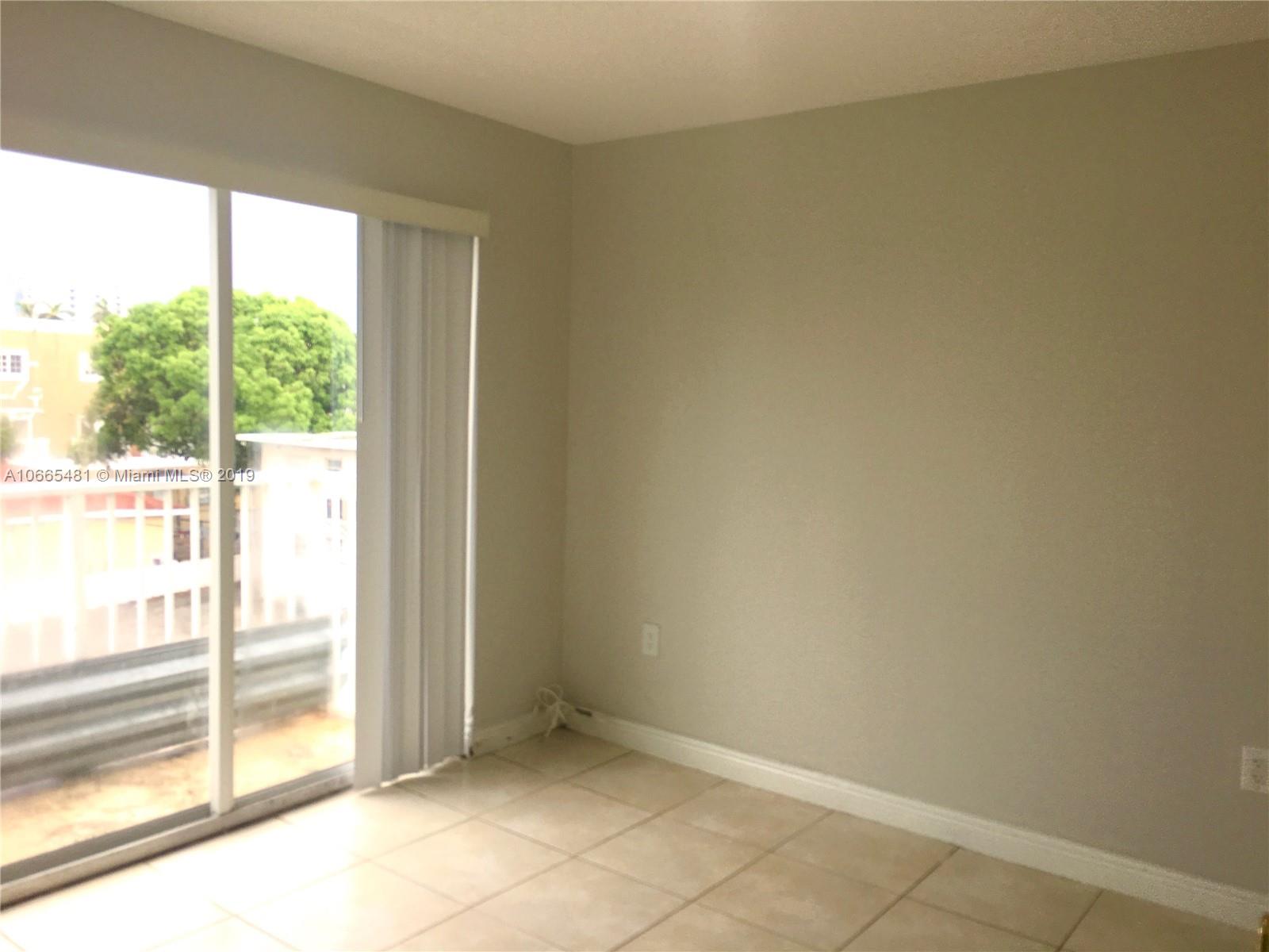 1453 Southwest 3rd Street, Unit 305 Miami, FL 33135 - Photo 6 of 12 a view of an empty room and window