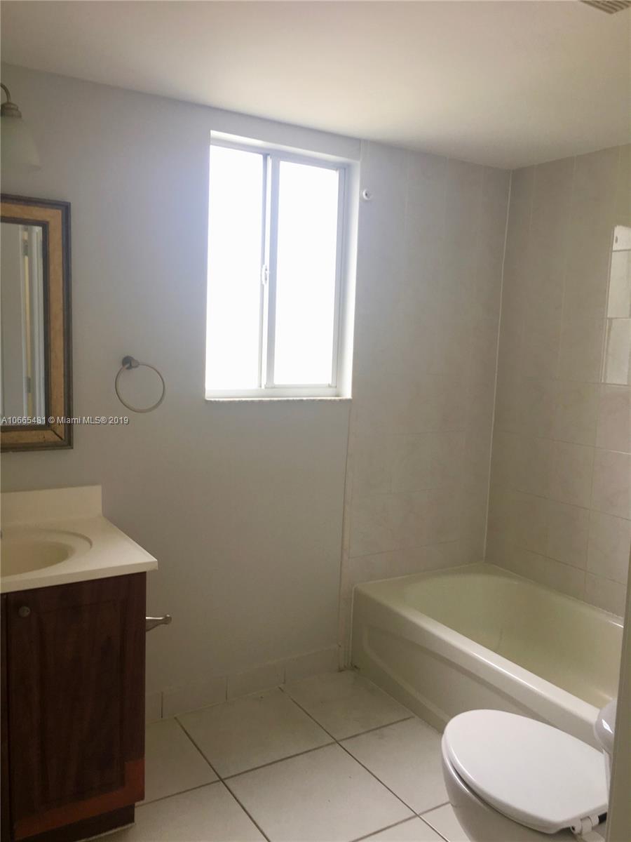 1453 Southwest 3rd Street, Unit 305 Miami, FL 33135 - Photo 10 of 12 a bathroom with a sink a toilet and bathtub
