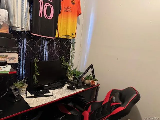 a bedroom with furniture and a flat screen tv