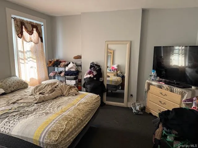 a room with a chair and flat screen tv