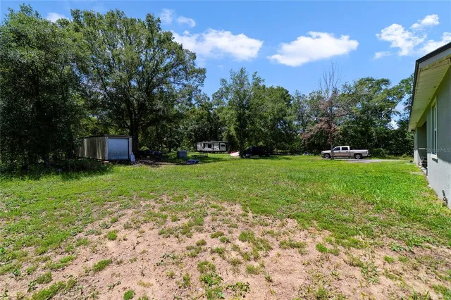 a backyard of a house with lots of green space