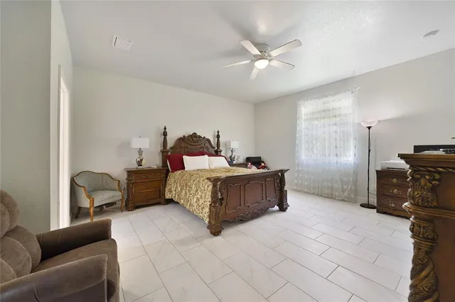 a bedroom with a bed and couch